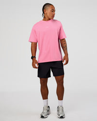 Man wearing CFT BNE 26 FLXCotton Oversized Tee in Candy Pink | Model:Malebo | Size:M