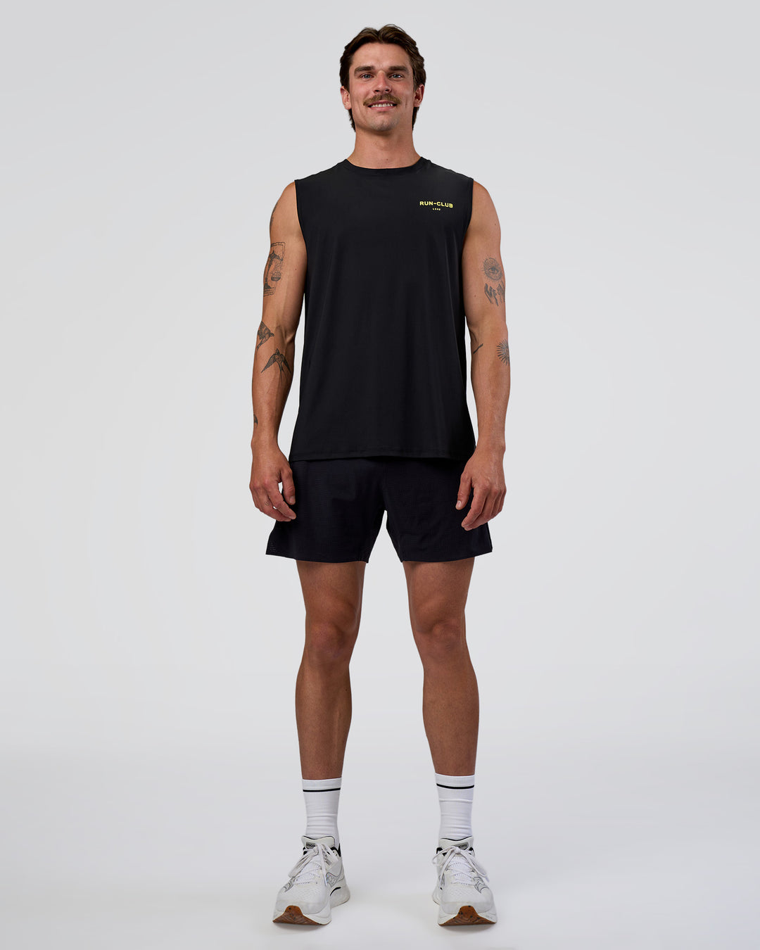 Man wearing Cadence RUN CLUB Muscle Tank - Black-Yellow Fizz | Model:Konnor | Size:M