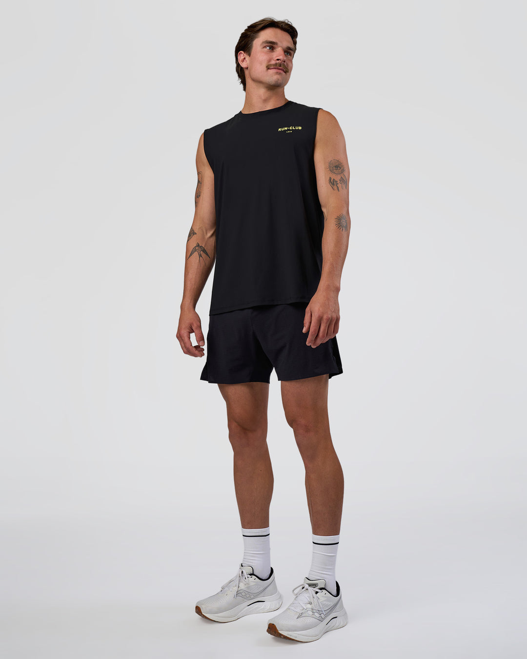 Man wearing Cadence RUN CLUB Muscle Tank - Black-Yellow Fizz | Model:Konnor | Size:M