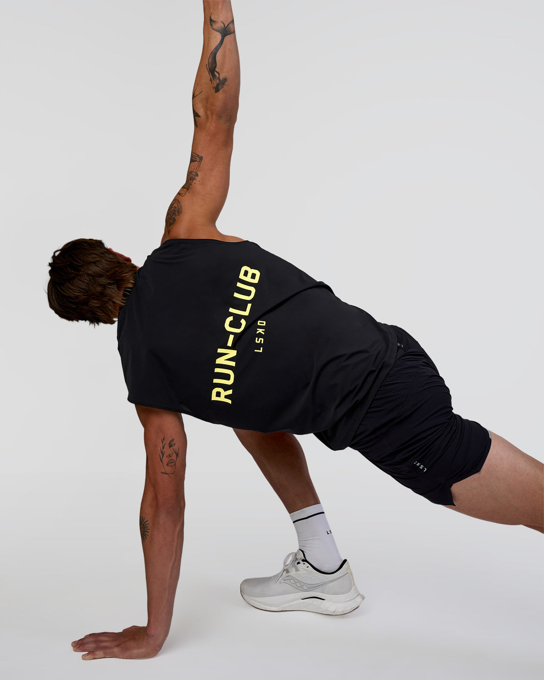 Man wearing Cadence RUN CLUB Muscle Tank - Black-Yellow Fizz | Model:Konnor | Size:M