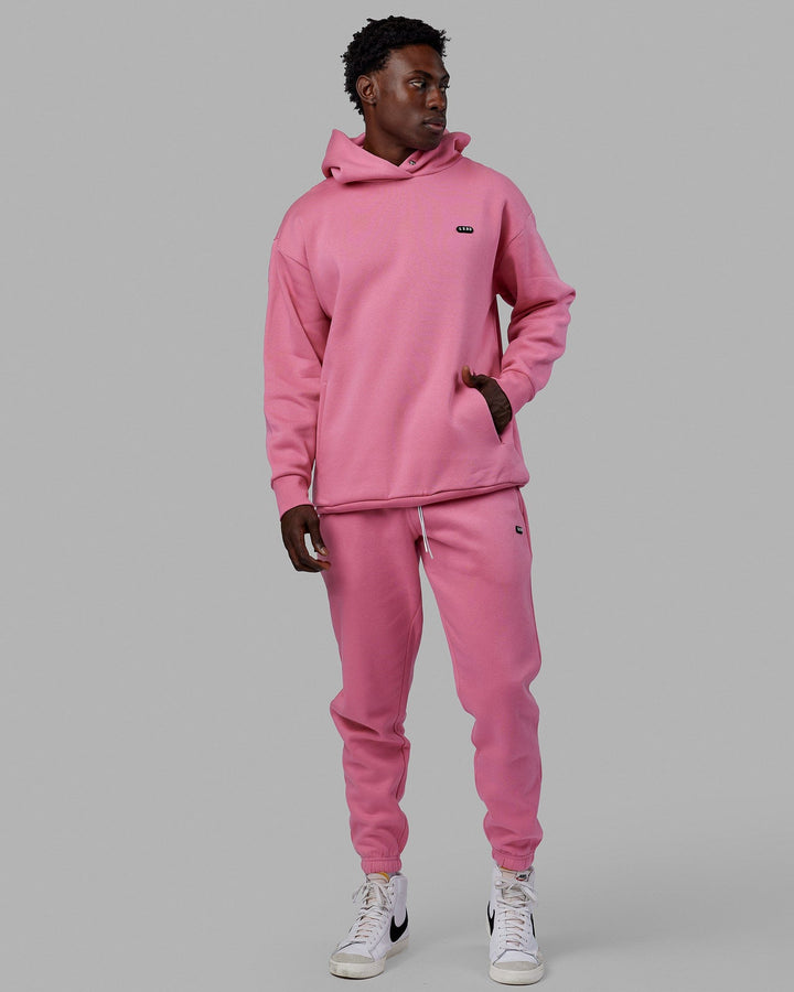 Man wearing Unisex Capsule Hoodie Oversize - Pink Rose