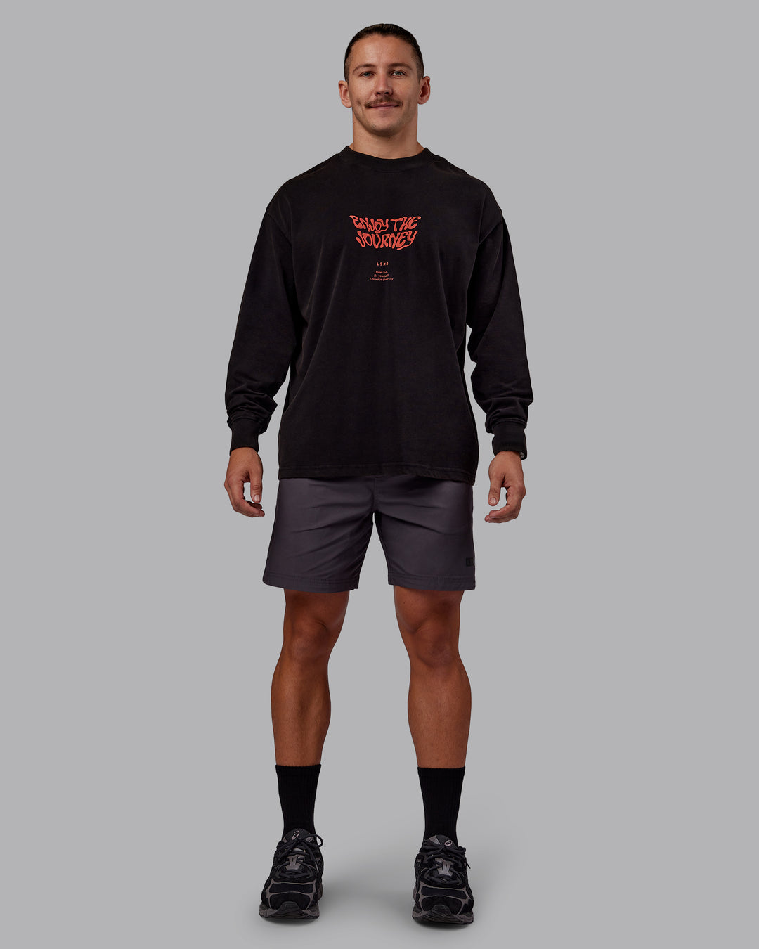 Man wearing Chrome Washed Heavyweight Oversized Long Sleeve Tee - Black-Ultra Orange | Model:Jaiden | Size:M