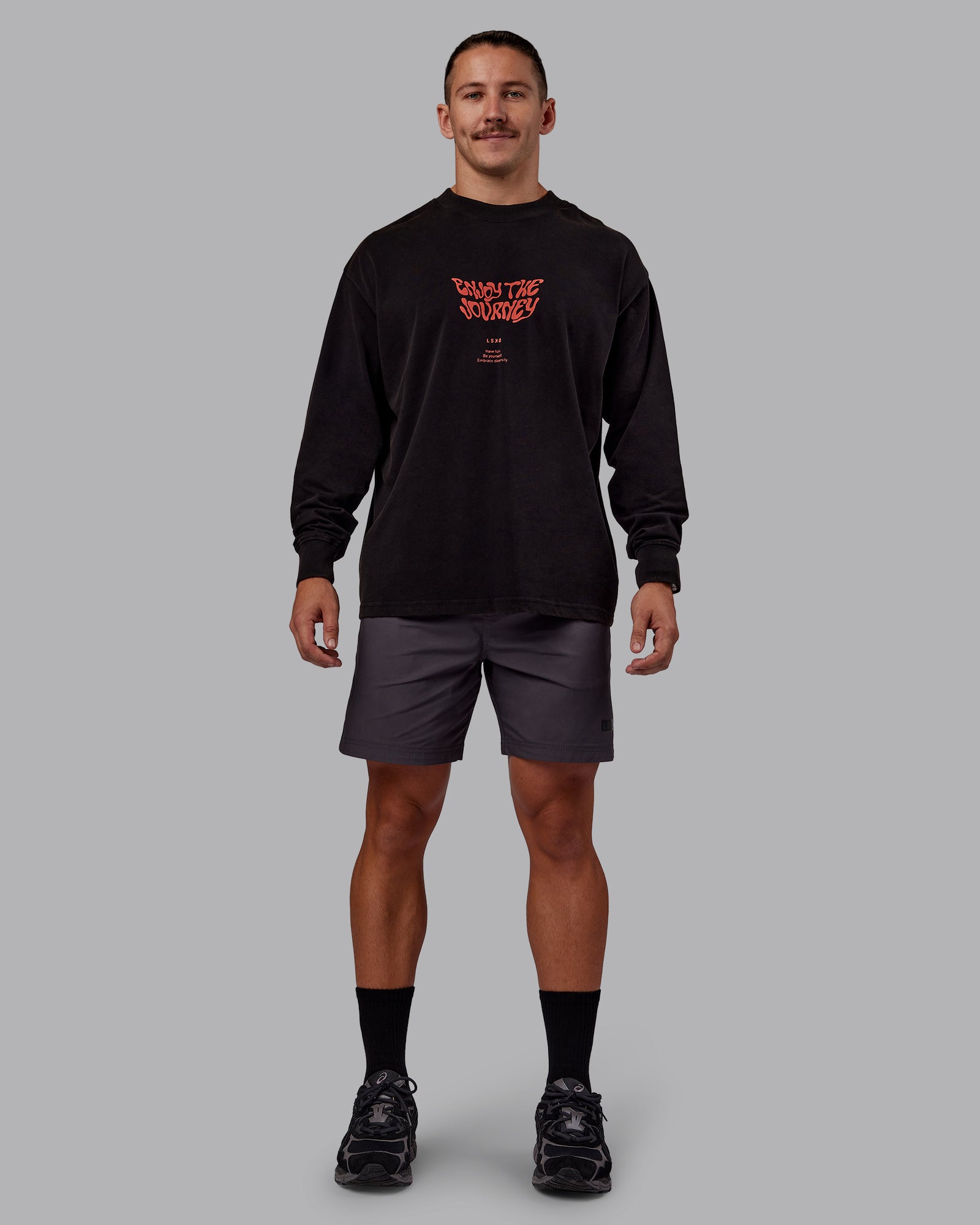 Man wearing Chrome Washed Heavyweight Oversized Long Sleeve Tee - Black-Ultra Orange | Model:Jaiden | Size:M