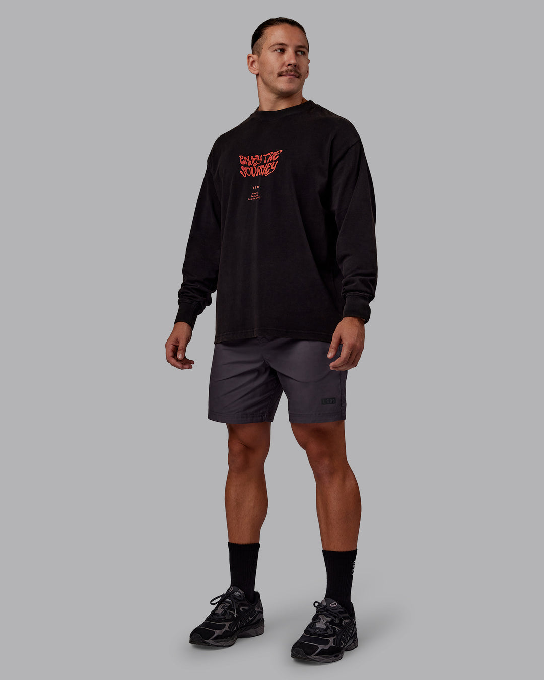Man wearing Chrome Washed Heavyweight Oversized Long Sleeve Tee - Black-Ultra Orange | Model:Jaiden | Size:M