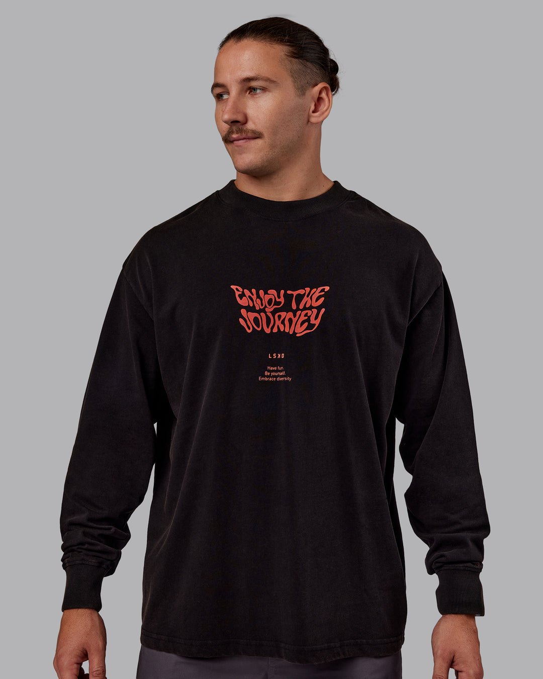 Man wearing Chrome Washed Heavyweight Oversized Long Sleeve Tee - Black-Ultra Orange | Model:Jaiden | Size:M