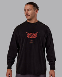 Man wearing Chrome Washed Heavyweight Oversized Long Sleeve Tee - Black-Ultra Orange | Model:Jaiden | Size:M