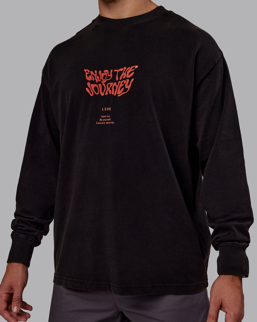 Man wearing Chrome Washed Heavyweight Oversized Long Sleeve Tee - Black-Ultra Orange | Model:Jaiden | Size:M