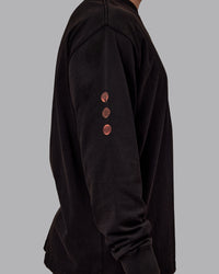 Man wearing Chrome Washed Heavyweight Oversized Long Sleeve Tee - Black-Ultra Orange | Model:Jaiden | Size:M