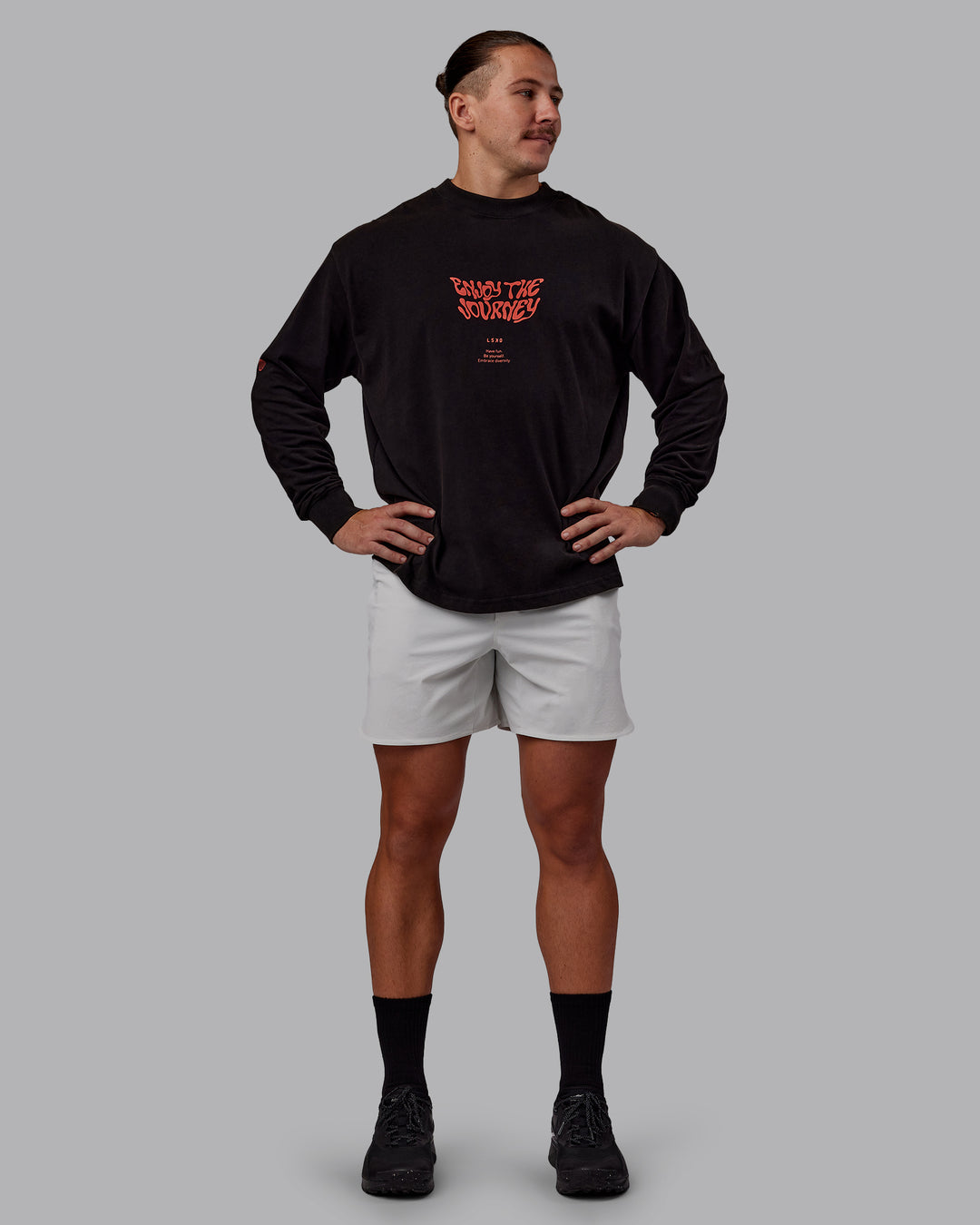 Man wearing Chrome Washed Heavyweight Oversized Long Sleeve Tee - Black-Ultra Orange | Model:Jaiden | Size:M
