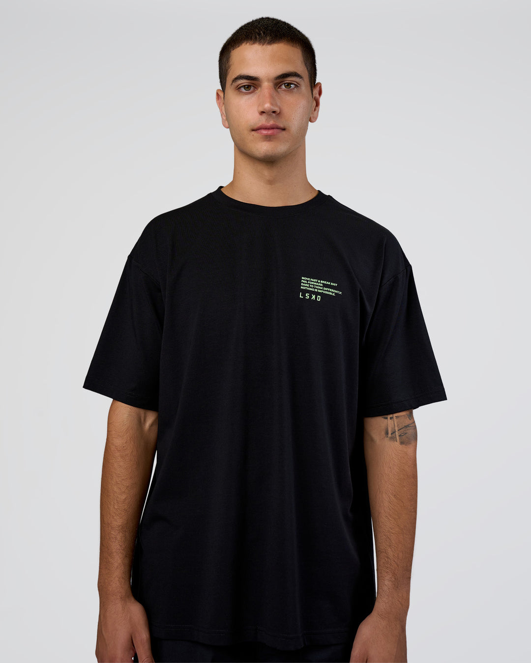 Man wearing Coffee Run FLXCotton Oversized Tee - Black-Solar Lime | Model:Zoran | Size:L