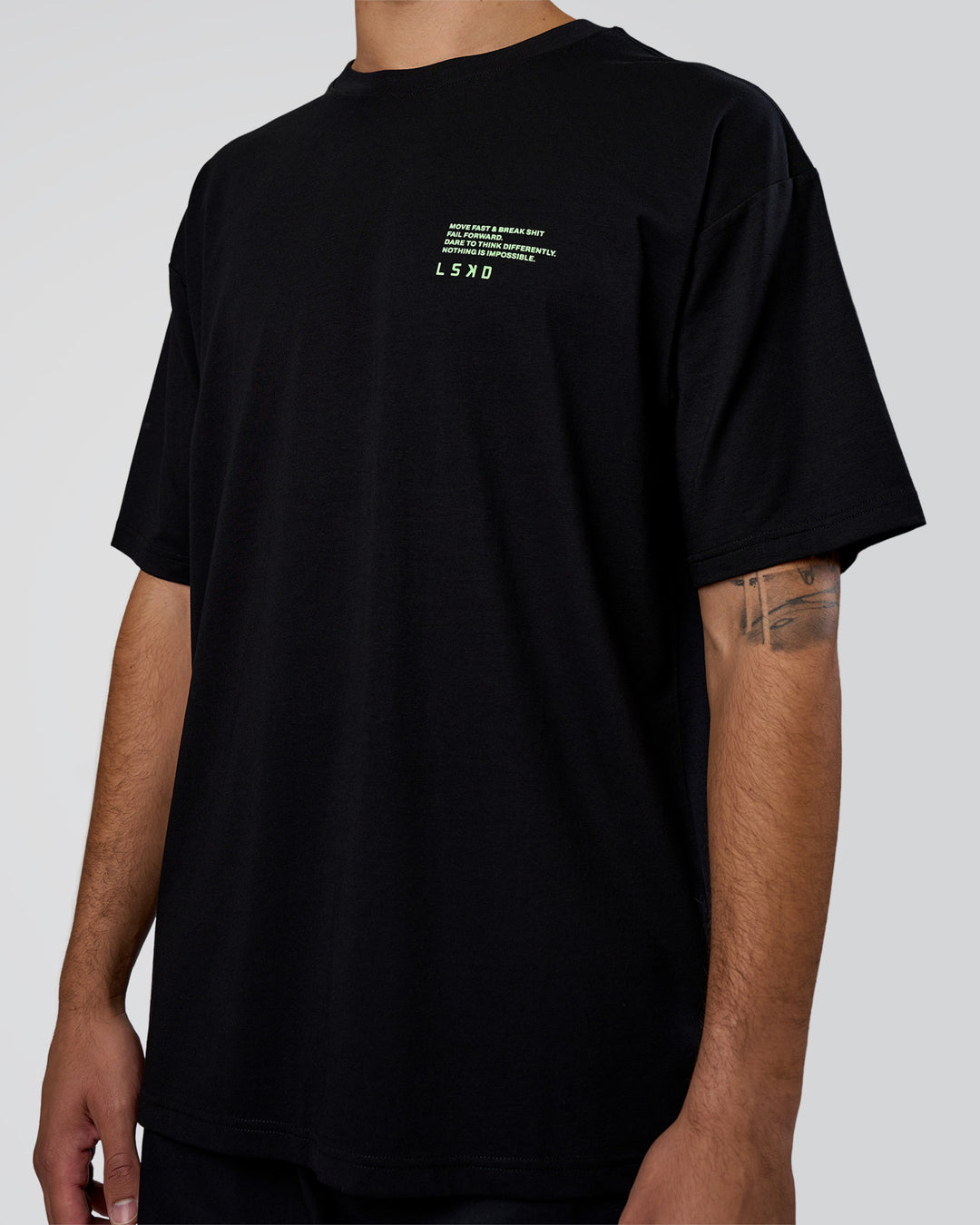 Man wearing Coffee Run FLXCotton Oversized Tee - Black-Solar Lime | Model:Zoran | Size:L