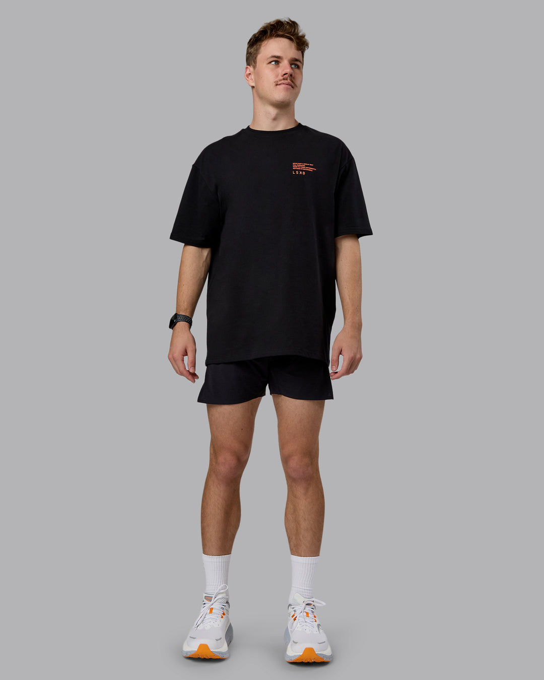 Man wearing Coffee Run FLXCotton Oversized Tee - Black-Ultra Orange | Model:Cameron | Size:M