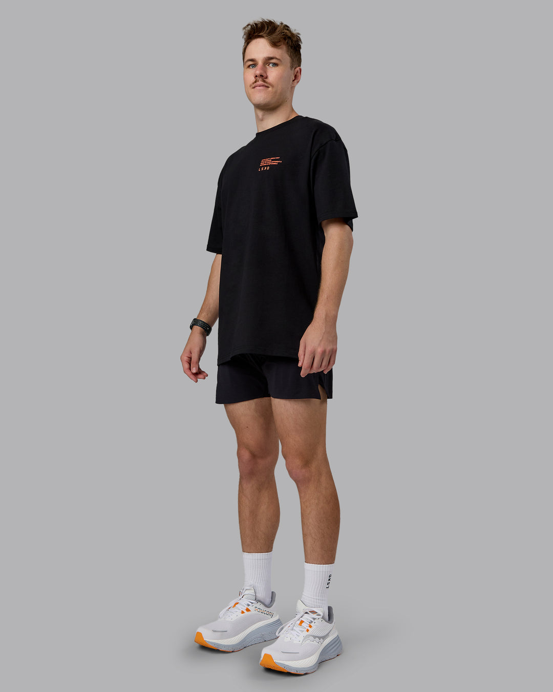 Man wearing Coffee Run FLXCotton Oversized Tee - Black-Ultra Orange | Model:Cameron | Size:M