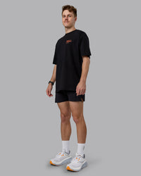 Man wearing Coffee Run FLXCotton Oversized Tee - Black-Ultra Orange | Model:Cameron | Size:M
