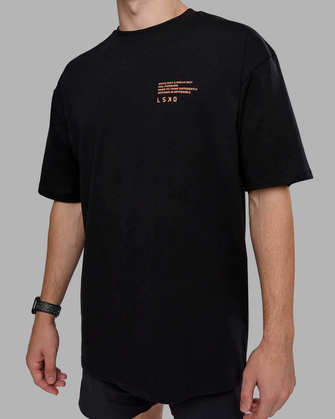 Man wearing Coffee Run FLXCotton Oversized Tee - Black-Ultra Orange | Model:Cameron | Size:M