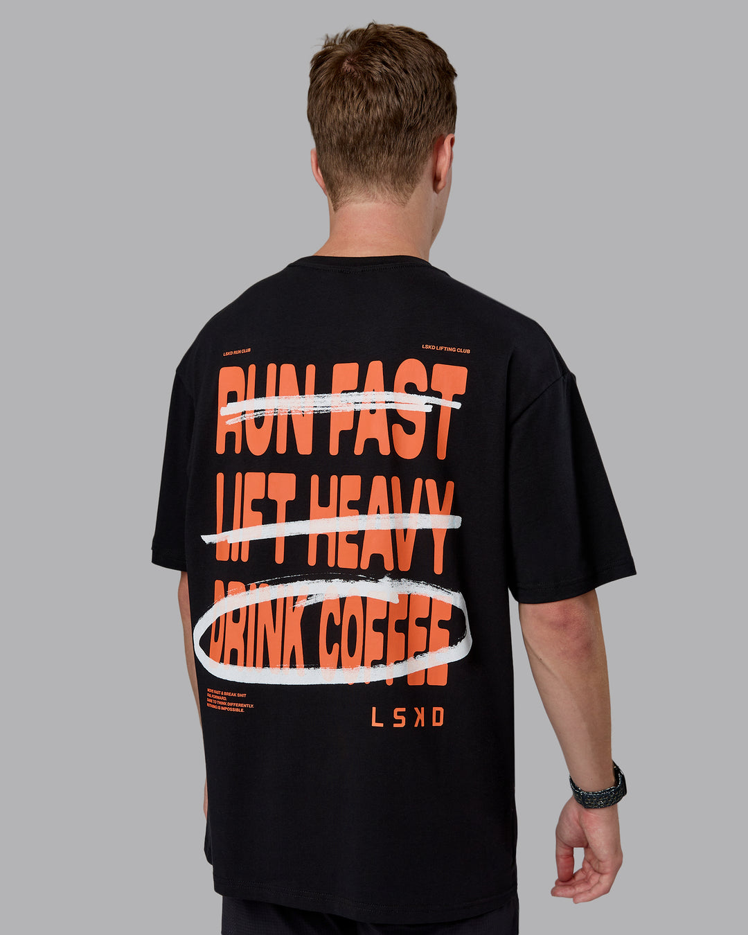 Man wearing Coffee Run FLXCotton Oversized Tee - Black-Ultra Orange | Model:Cameron | Size:M