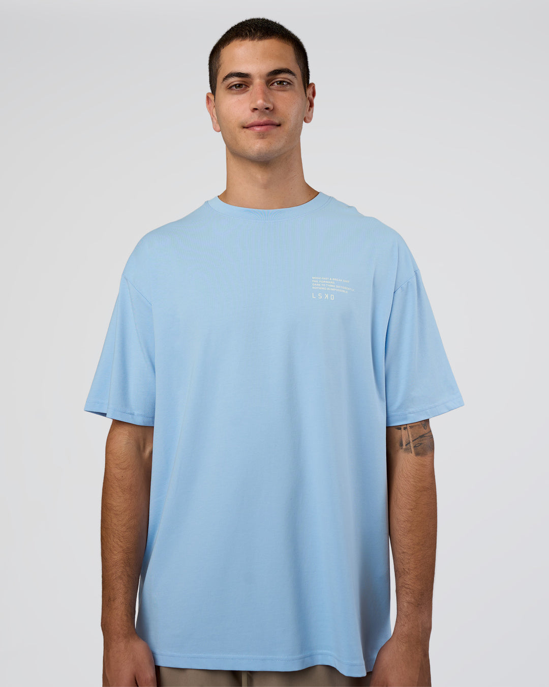 Man wearing Coffee Run FLXCotton Oversized Tee - Open Air-White | Model:Zoran | Size:L