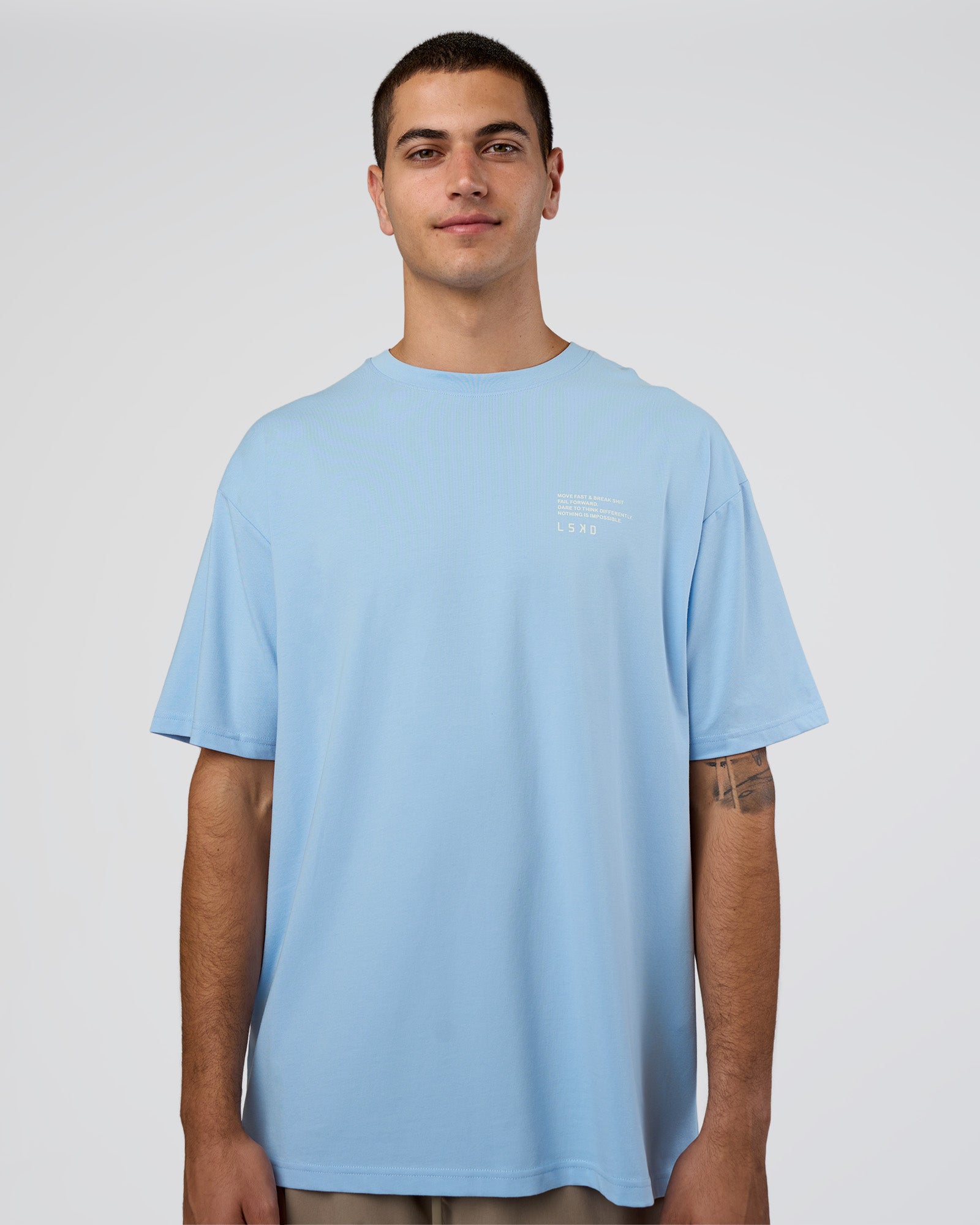 Man wearing Coffee Run FLXCotton Oversized Tee - Open Air-White | Model:Zoran | Size:L