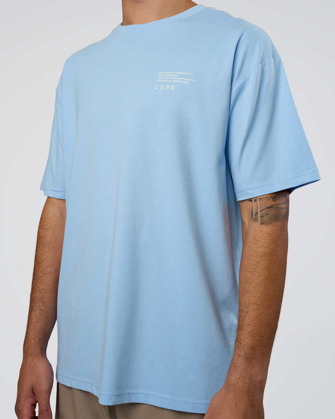 Man wearing Coffee Run FLXCotton Oversized Tee - Open Air-White | Model:Zoran | Size:L