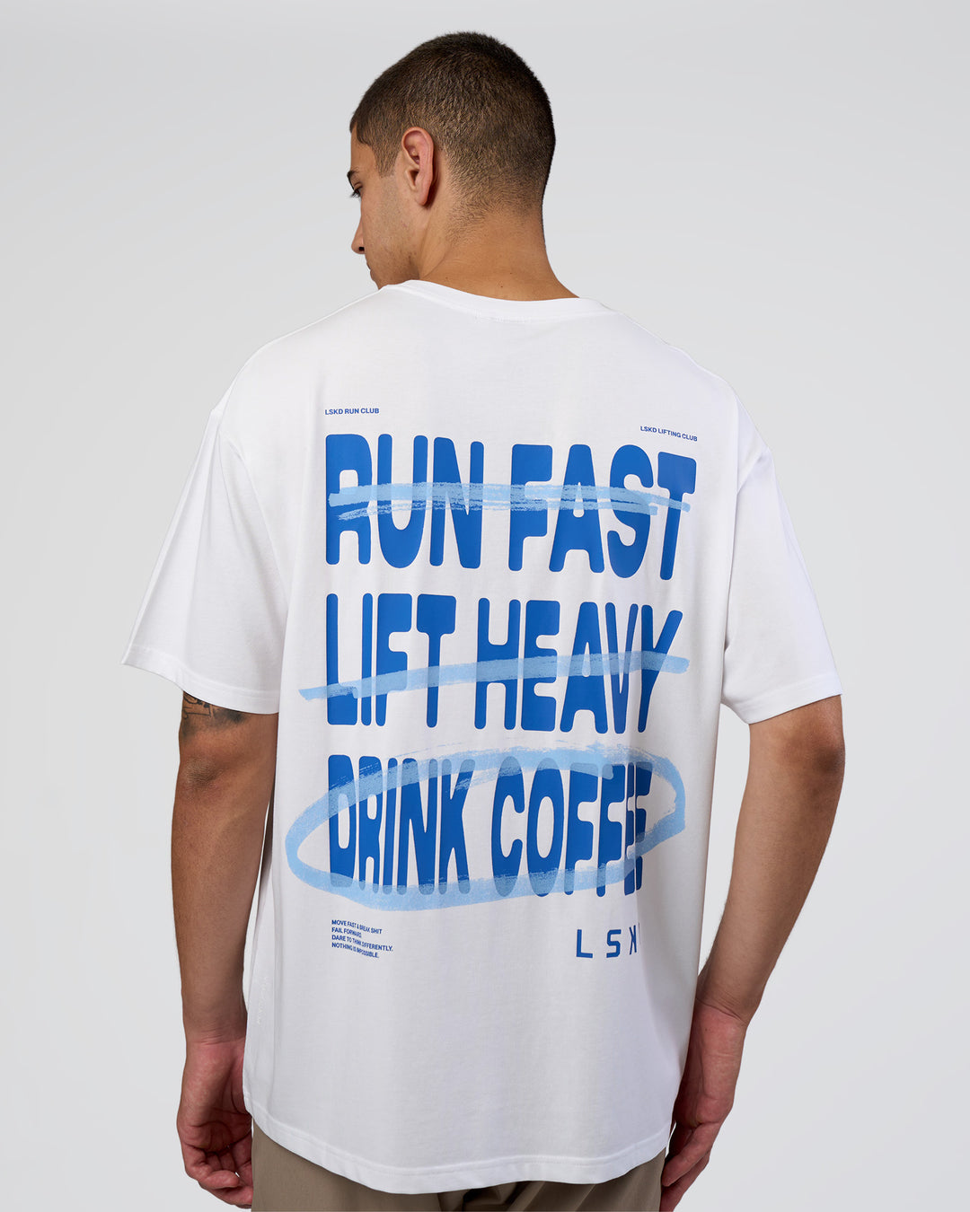 Man wearing Coffee Run FLXCotton Oversized Tee - White-Electric Indigo | Model:Zoran | Size:L