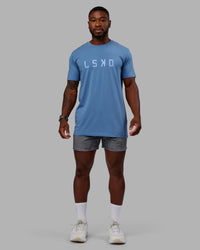 Man wearing Washed Daily 5" Shorts - Circular Grey
