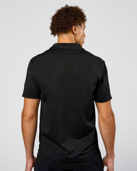 Man wearing Drive Seamless Polo - Black | Model:Leandro | Size:M