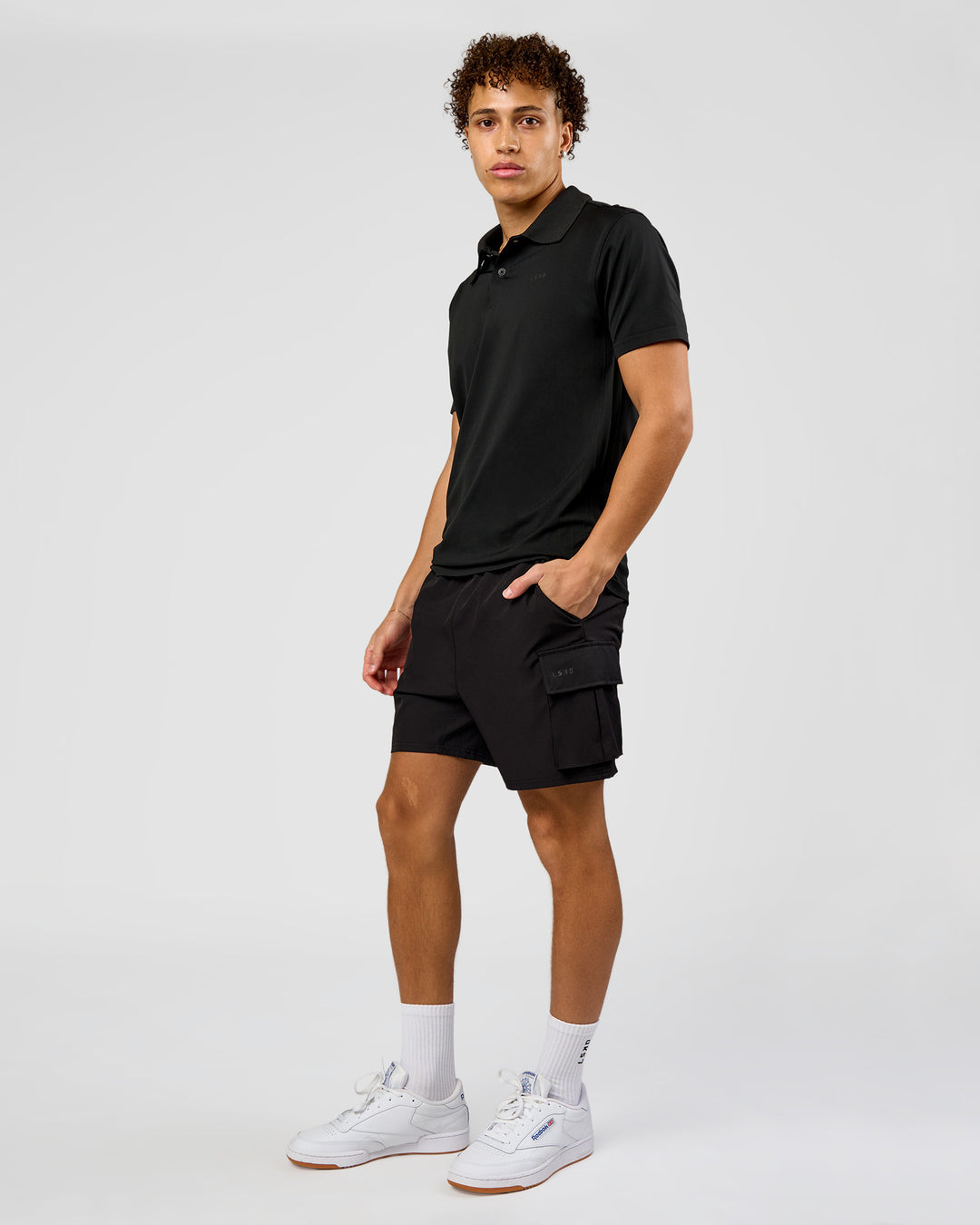 Man wearing Drive Seamless Polo - Black | Model:Leandro | Size:M