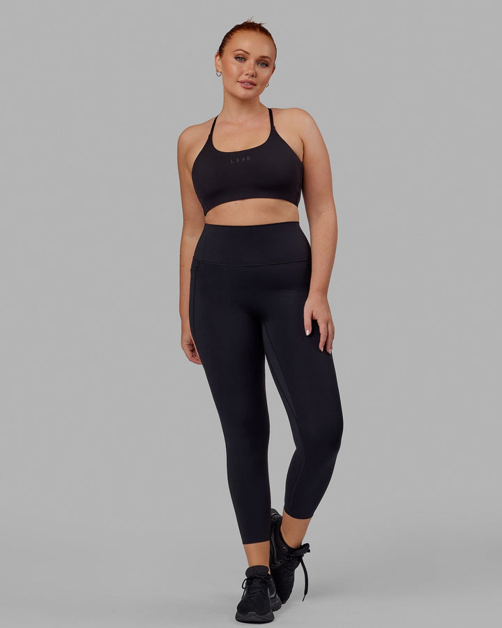 Woman wearing Elixir 7/8 Tights With Pockets - Black