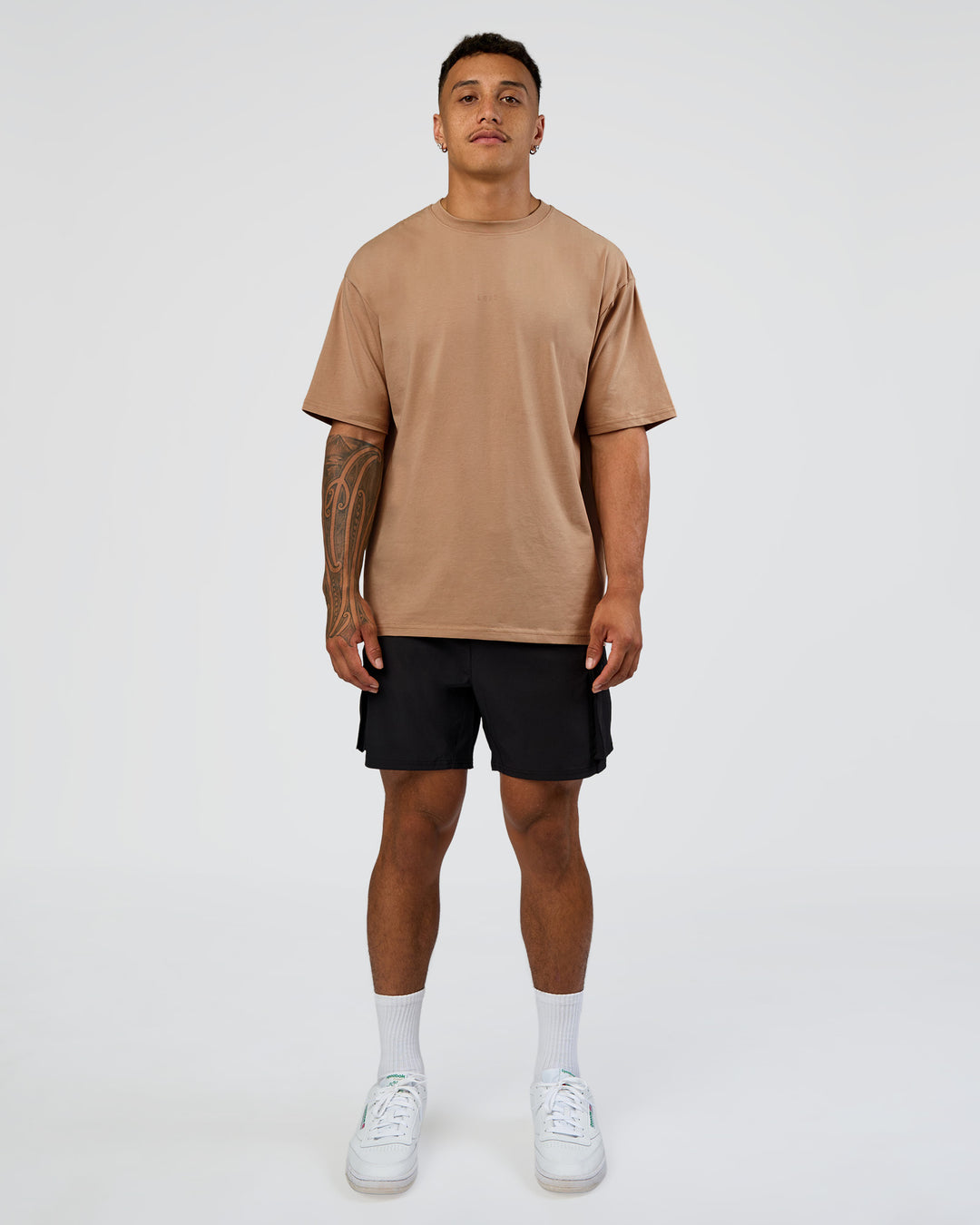 Man wearing Energy Stretch 6" Performance Cargo Short - Black | Model:Daarian | Size:M