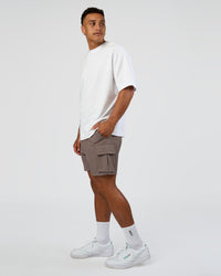 Man wearing Energy Stretch 6" Performance Cargo Short - Iron | Model:Daarian | Size:M