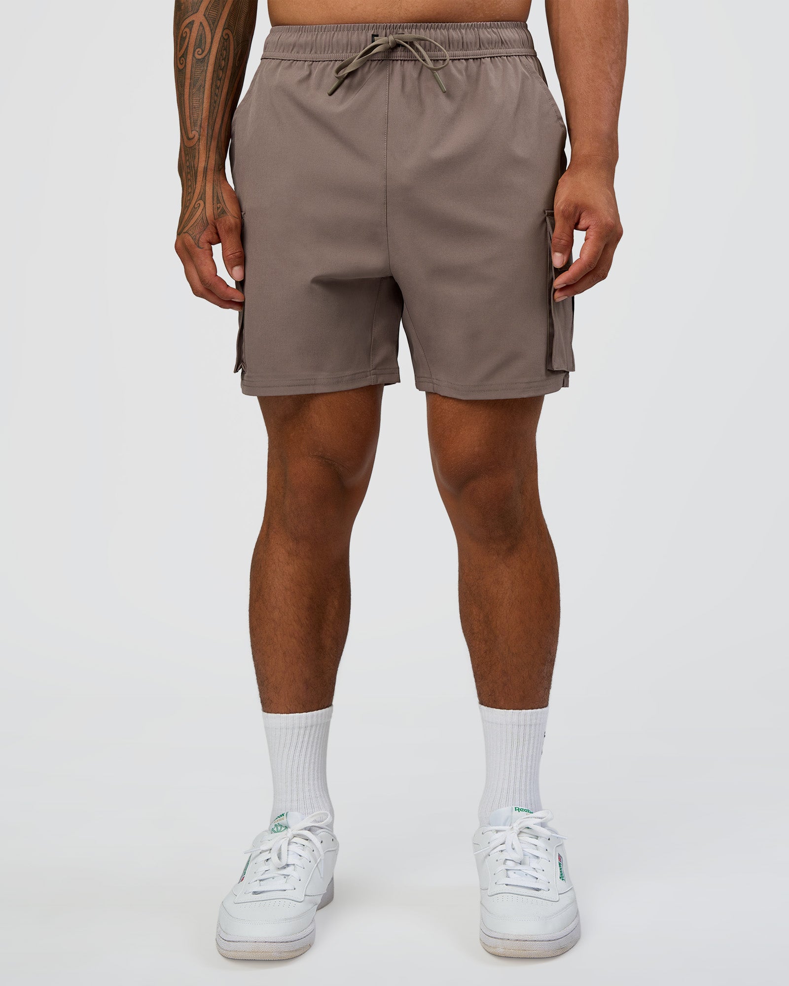 Man wearing Energy Stretch 6" Performance Cargo Short - Iron | Model:Daarian | Size:M