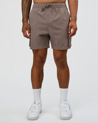 Man wearing Energy Stretch 6" Performance Cargo Short - Iron | Model:Daarian | Size:M