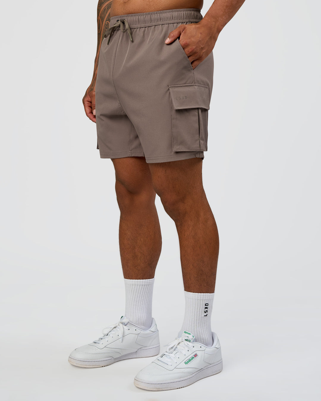Man wearing Energy Stretch 6" Performance Cargo Short - Iron | Model:Daarian | Size:M