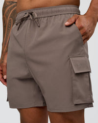Man wearing Energy Stretch 6" Performance Cargo Short - Iron | Model:Daarian | Size:M