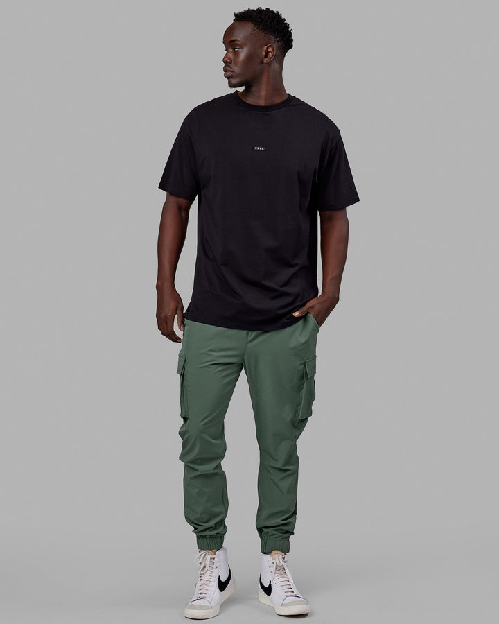 Man wearing Energy Stretch Performance Cargo Joggers - Dark Forest