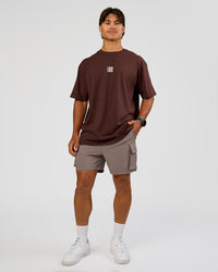 Man wearing Everyday Elevation FLXCotton Oversized Tee - Hot Chocolate-Off White | Model:George | Size:M