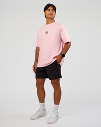 Man wearing Everyday Elevation FLXCotton Oversized Tee - Marshmallow-Black | Model:George | Size:M