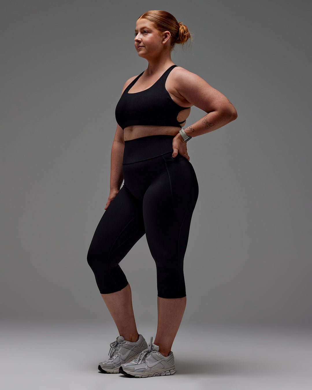 Woman wearing Fusion Ultra High-Rise 3/4 Legging Pockets - Black | Model:Caity | Size:M
