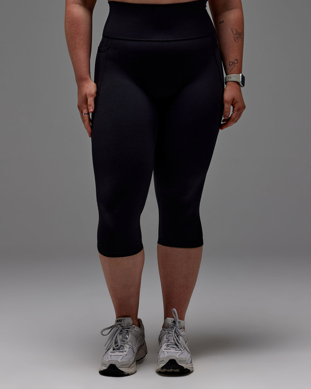 Woman wearing Fusion Ultra High-Rise 3/4 Legging Pockets - Black | Model:Caity | Size:M