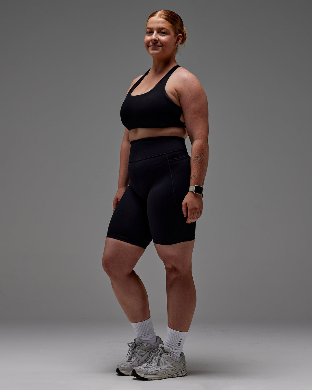 Woman wearing Fusion Ultra High-Rise 9&quot; Short Pockets - Black | Model:Caity | Size:M