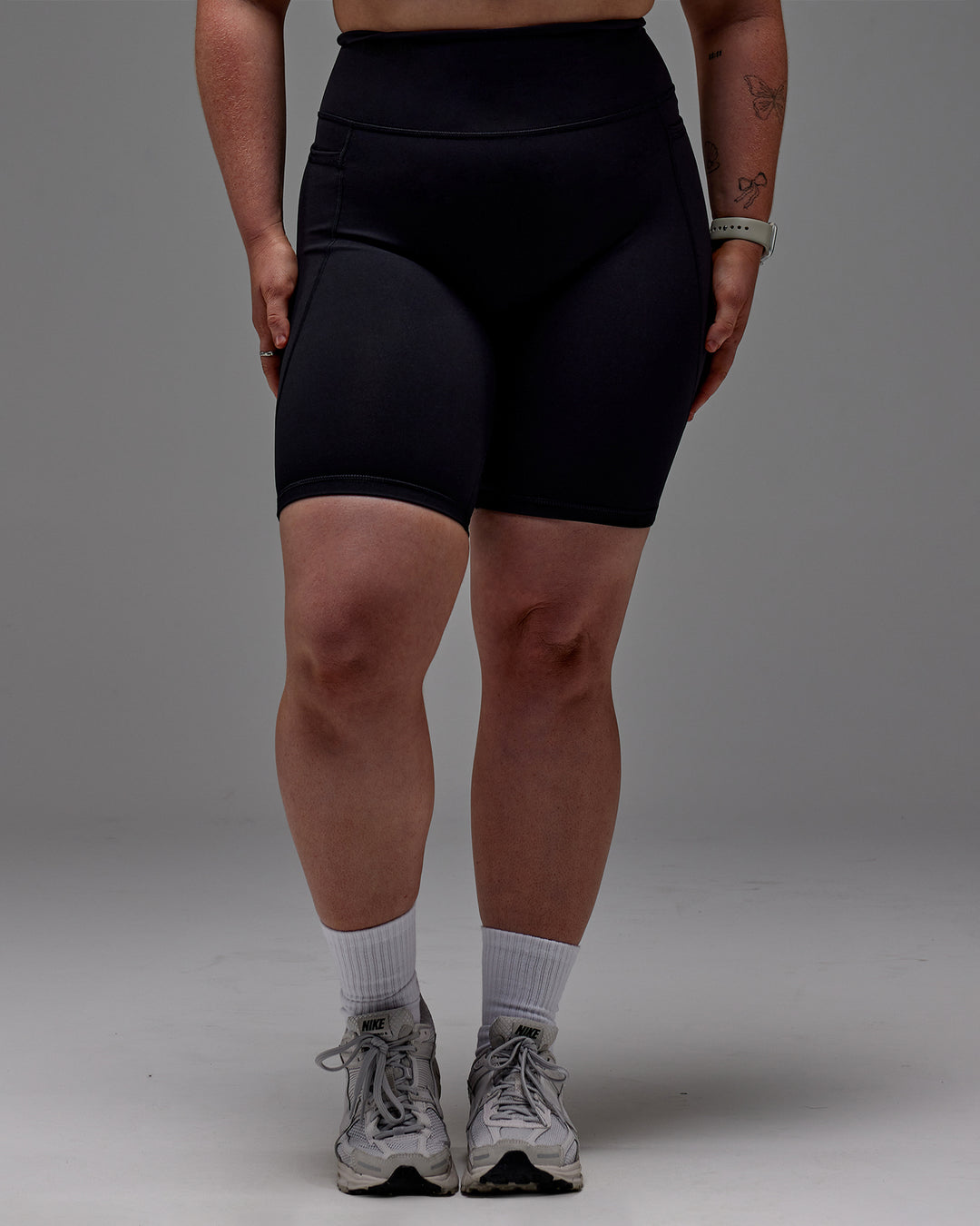 Woman wearing Fusion Ultra High-Rise 9&quot; Short Pockets - Black | Model:Caity | Size:M