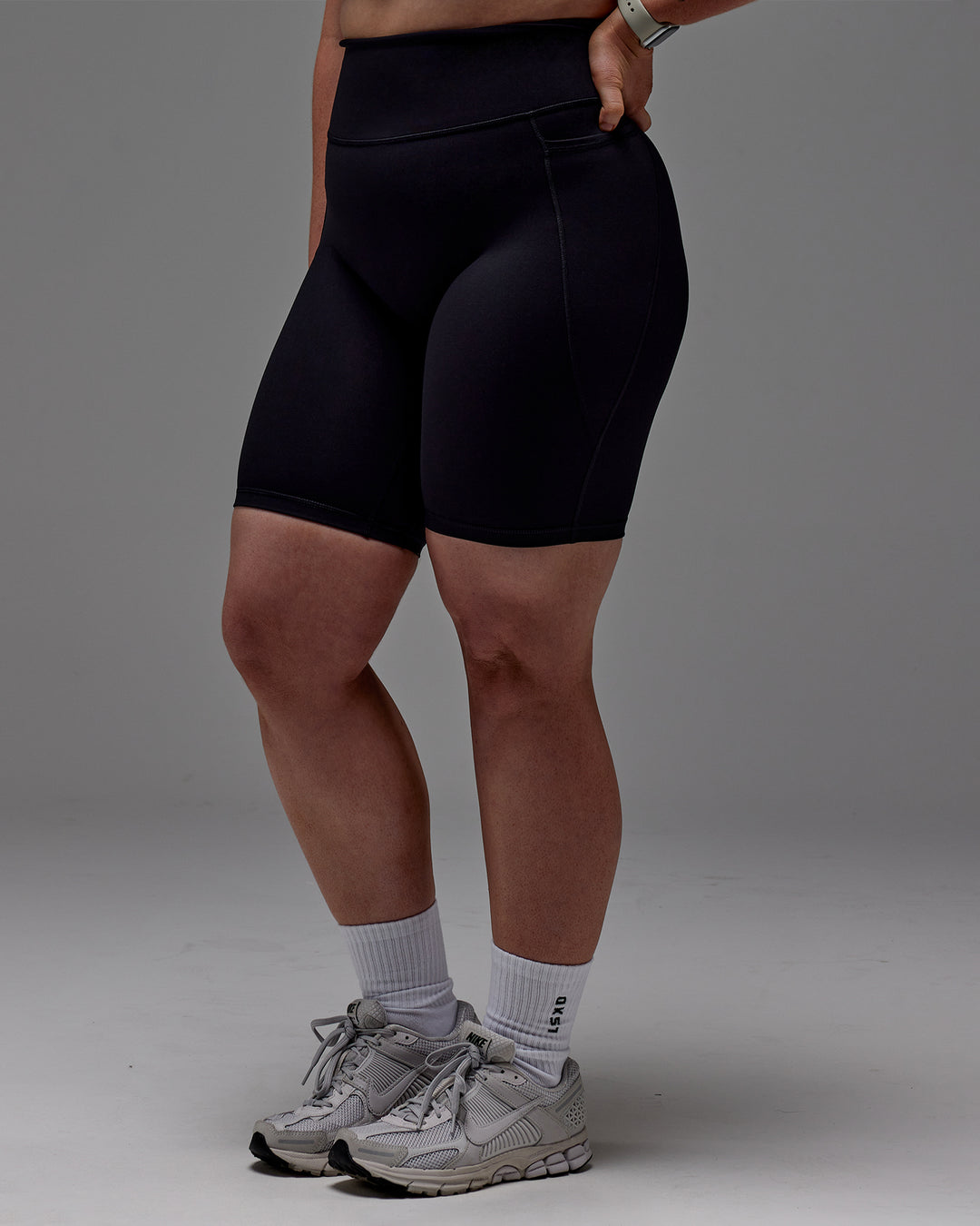 Woman wearing Fusion Ultra High-Rise 9&quot; Short Pockets - Black | Model:Caity | Size:M