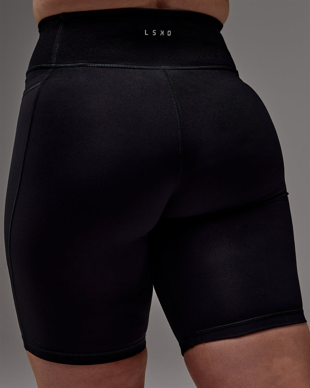 Woman wearing Fusion Ultra High-Rise 9&quot; Short Pockets - Black | Model:Caity | Size:M