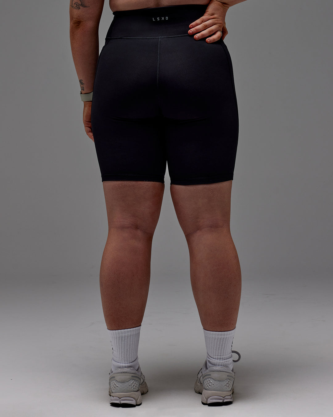 Woman wearing Fusion Ultra High-Rise 9&quot; Short Pockets - Black | Model:Caity | Size:M
