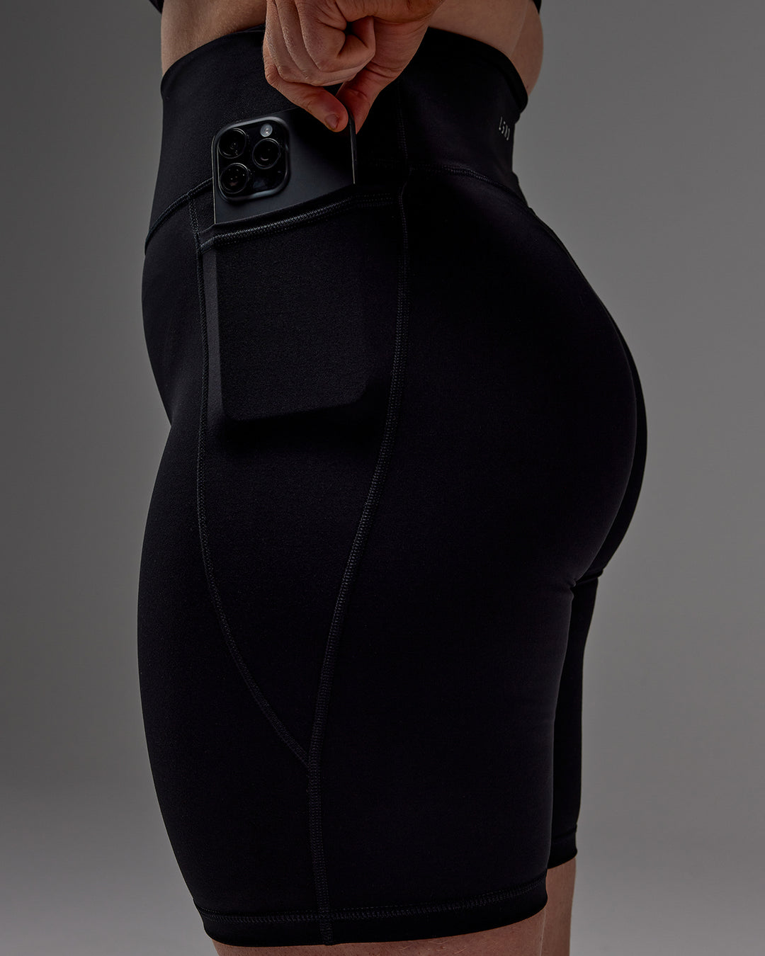 Woman wearing Fusion Ultra High-Rise 9&quot; Short Pockets - Black | Model:Caity | Size:M