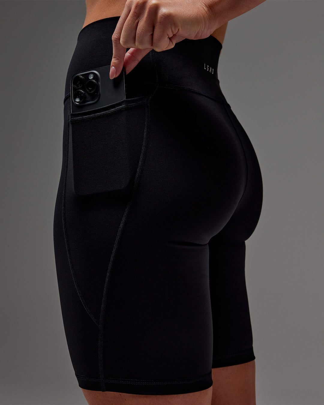 Woman wearing Fusion Bike Short With Pockets in Black | Model:Meg | Size:M