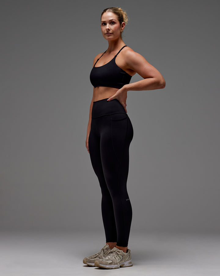 Woman wearing Fusion Full Length Tight With Pockets in Black | Model:Meg | Size:M
