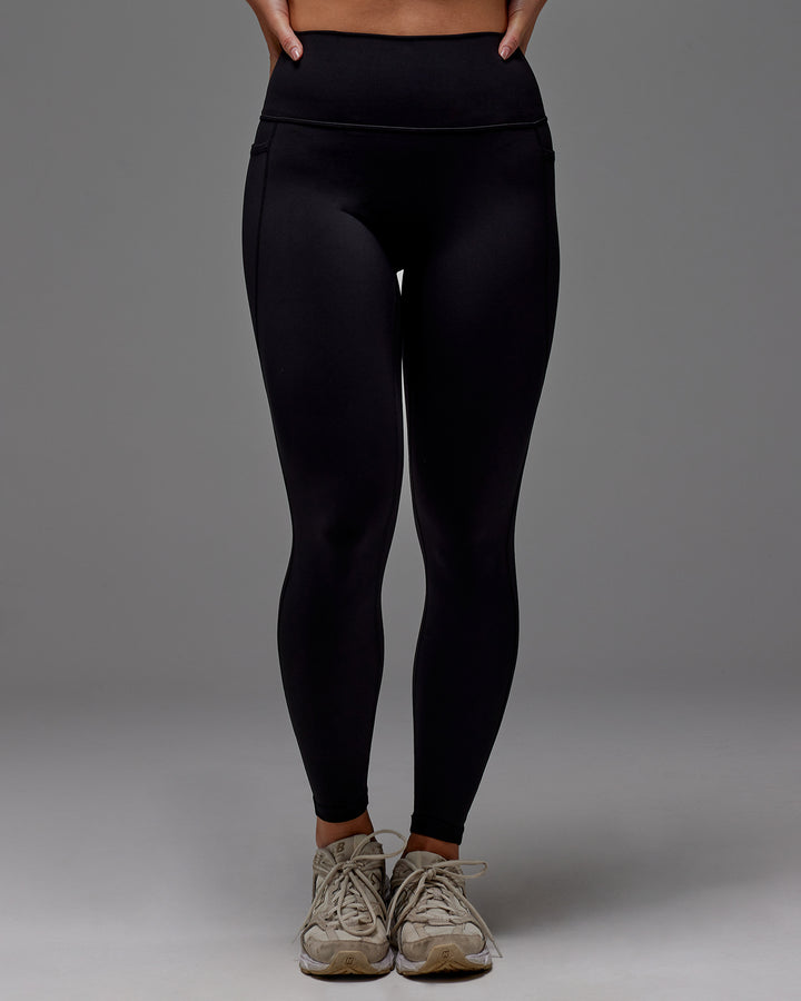 Woman wearing Fusion Full Length Tight With Pockets in Black | Model:Meg | Size:M
