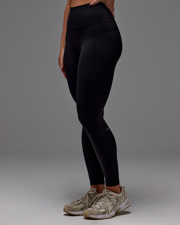 Woman wearing Fusion Full Length Tight With Pockets in Black | Model:Meg | Size:M
