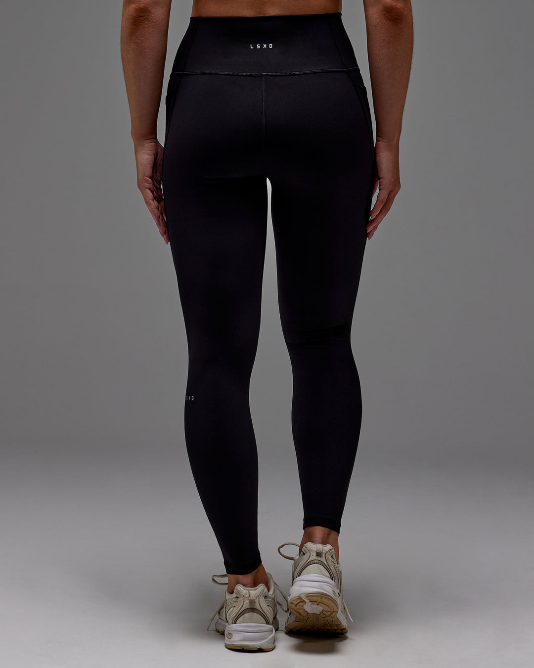 Woman wearing Fusion Full Length Tight With Pockets in Black | Model:Meg | Size:M